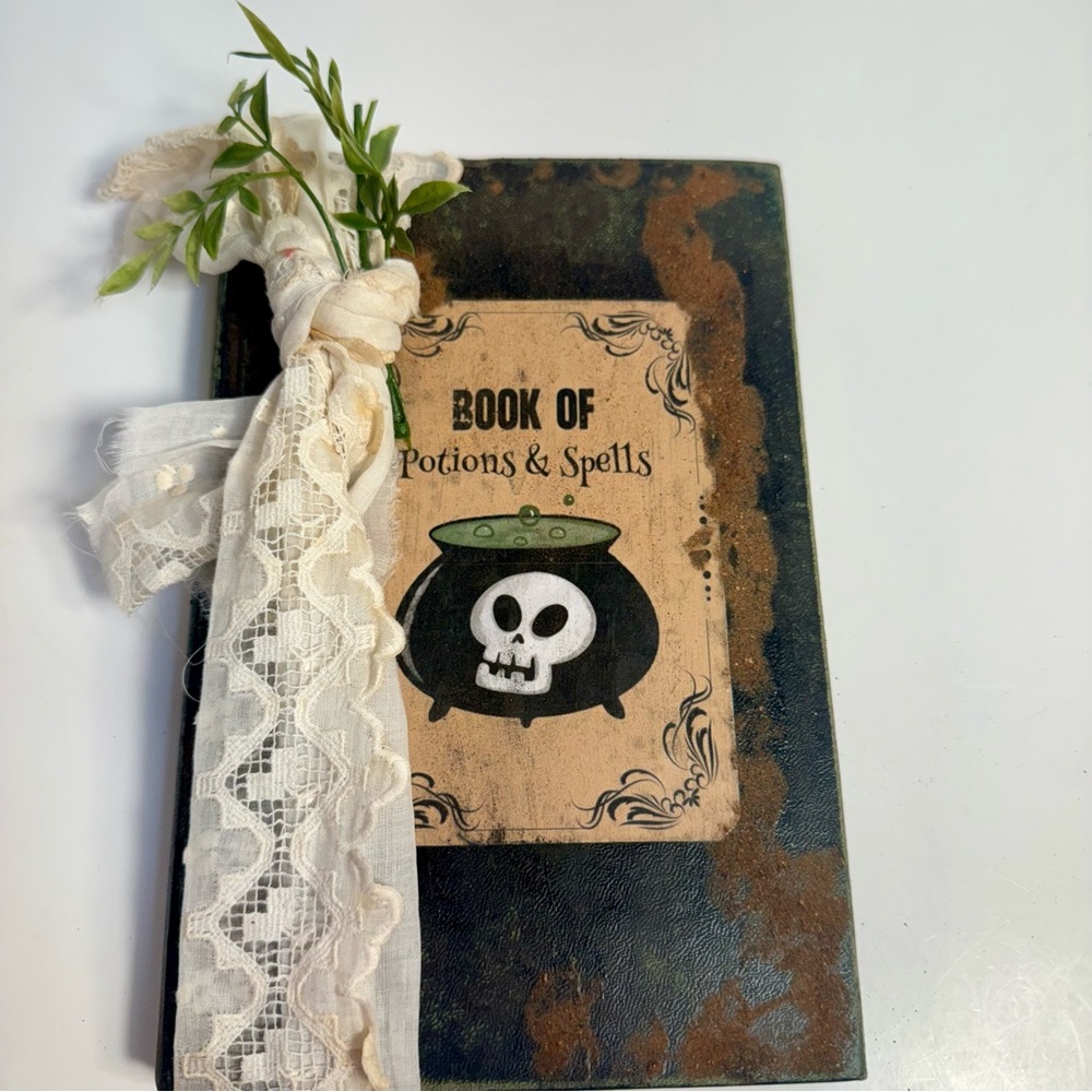 Handmade Halloween scary potions book decoration. Old book craft Halloween